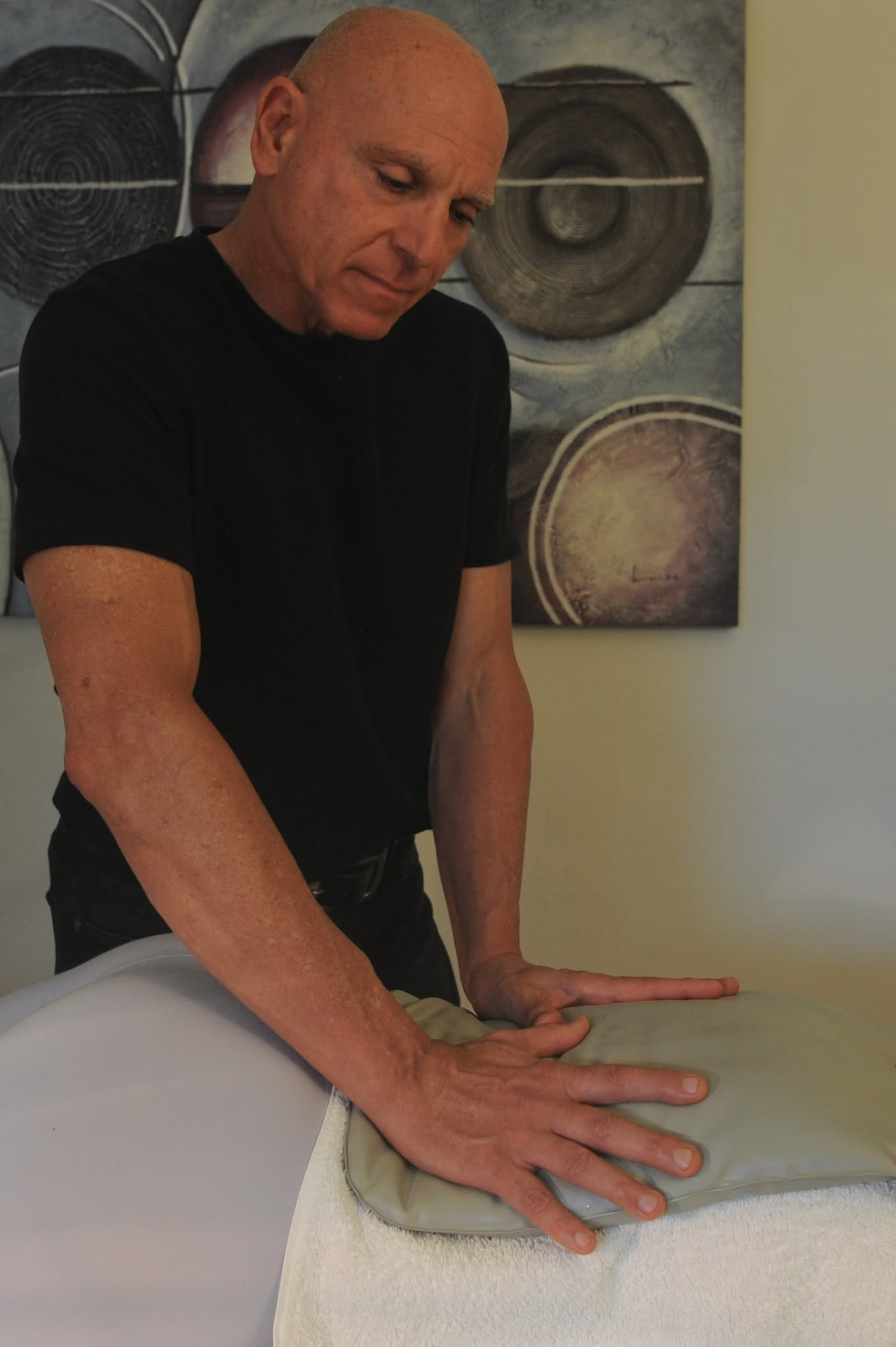 Chris Youakim preparing the treatment table at Chiroflexion in Terrigal